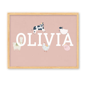 Children's personalised name print. The name Olivia is surrounded by farm animals. The print is styled in a wooden frame. 